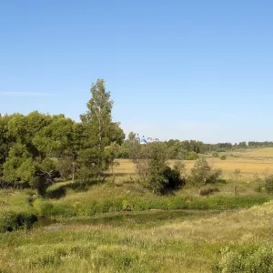 Rural landscape with a small river and sloping field