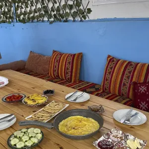 Rustic wooden table features a spread of moroccan breakfast food