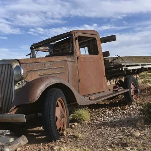 Rusty old car, classic car in barren landscape Rusty old car, classic car in barren landscape