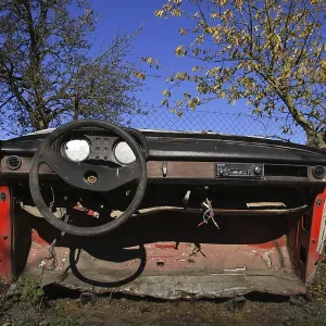 Rusty vintage car cut in half on a sunny day in autumn garden Prague Czech republic Rusty vintage car cut in half on a sunny day in autumn garden Prague Czech republic