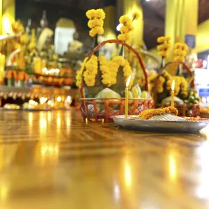 Sacrifices with candles, in front of numerous Buddhas and the City Pillar