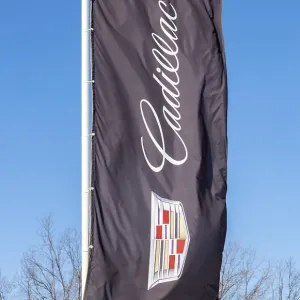 SAMARA, RUSSIA - MARCH 20, 2016: Dealership flag of Cadillac over blue sky SAMARA, RUSSIA - MARCH 20, 2016: Dealership flag of Cadillac over blue sky