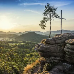 Sandstone rock with pine tree and summit cross
