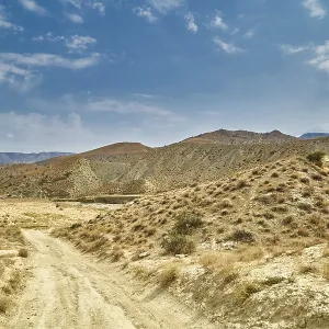 A sandy road in the mountains of Asia