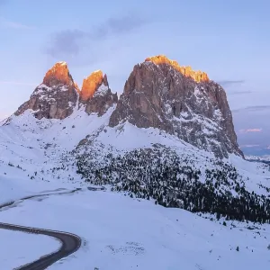 The Sassolungo in reddish light during sunrise