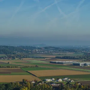 The scene shows a spacious landscape with agricultural fields and small villages The scene shows a spacious landscape with agricultural fields and small villages