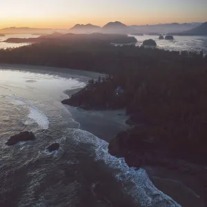 A scenic coastline at sunset with waves crashing on the beach A scenic coastline at sunset with waves crashing on the beach