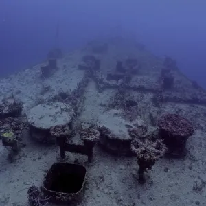 A ship deck covered with coral lies in the sea A ship deck covered with coral lies in the sea