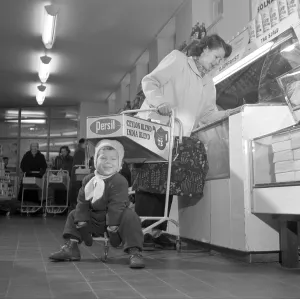 Shopping in the 1950s. A woman shops in a self service store