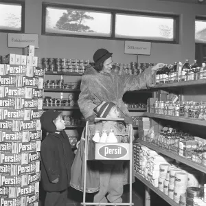 Shopping in the 1950s. A woman shops in a self service store