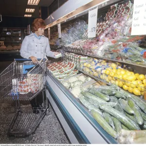 Shopping 1971. A woman shops in a self service store