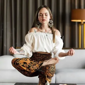 Full shot woman meditating inside Full shot woman meditating inside