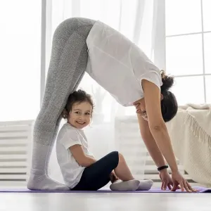 Full shot woman stretching with kid Full shot woman stretching with kid