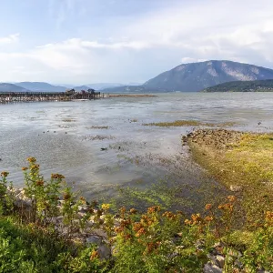 Shuswap lake reflecting a clear blue sky and framed by majestic mountains Shuswap lake reflecting a clear blue sky and framed by majestic mountains