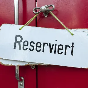 Sign, "Reserviert", German for "Reserved" in a train compartment of a historic cog railway Sign, "Reserviert", German for "Reserved" in a train compartment of a historic cog railway