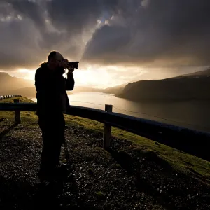 Silhouette of a photographer standing in front of dramatic
