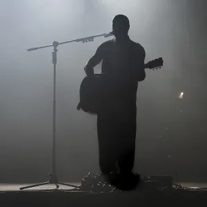 Silhouette of rock star with guitar on the stage in Lubin