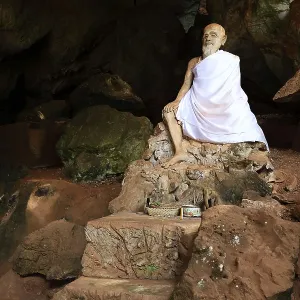 Sitting statue of a monk, cave temple Wat Tham Suwan Khuha