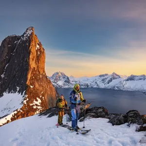 Two ski mountaineers at the Ascend of the steep mountain Segla Two ski mountaineers at the Ascend of the steep mountain Segla