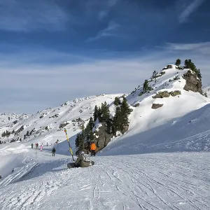 Ski route in Austrian Alps. Skiers skiing down the mountain ski slopes