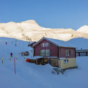 Ski Slope at 2061 Meters High Up and Overhead Cable Car and Mountain Peak in a Snowy Sunny Winter Day in Grindelwald
