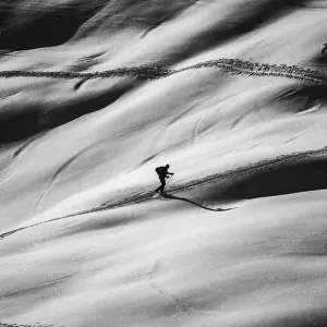Ski tourers ascending in black and white Ski tourers ascending in black and white