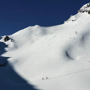 Ski tourers in ascent, avalanche Ski tourers in ascent, avalanche