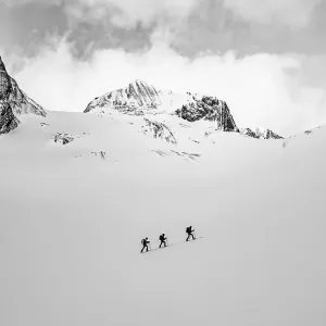 Three ski tourers in a lonely landscape Three ski tourers in a lonely landscape