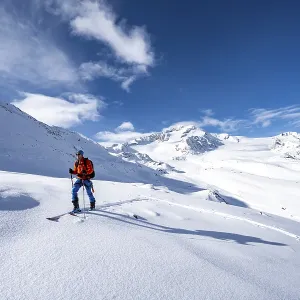 Ski tourers in a snow-covered mountain landscape Ski tourers in a snow-covered mountain landscape