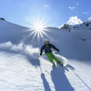 Skier with touring skis skiing in the snow