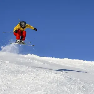 Skiers jumping on the ski slope