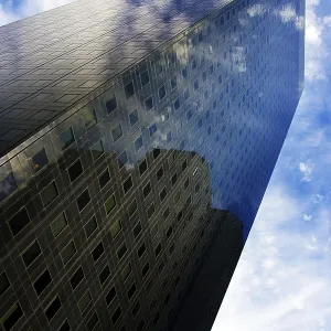 Skyscraper under cloudy blue sky