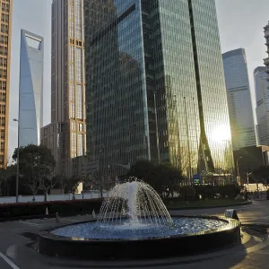 Skyscrapers with reflective glass facades and a fountain in the city center