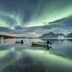 Small (Aurora borealis) motorboats anchoring in a bay Small (Aurora borealis) motorboats anchoring in a bay