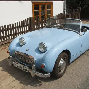 Small blue Austin Healey convertible classic car parked in urban environment Small blue Austin Healey convertible classic car parked in urban environment
