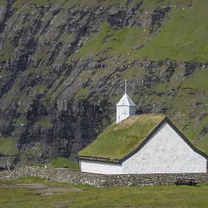 Small church with grass roof in mountain landscape Small church with grass roof in mountain landscape