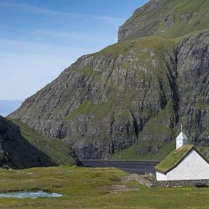Small church with grass roof in mountain landscape