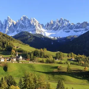 A small church in the midst of an autumnal mountain landscape in South Tyrol