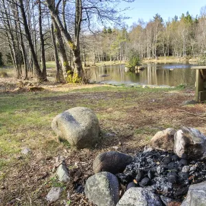 Small lake with campfire and bench in Jomfruland National Park Small lake with campfire and bench in Jomfruland National Park