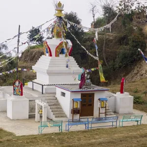 Small stupa with colorful prayer flags on a hill Small stupa with colorful prayer flags on a hill