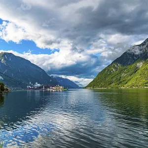 Small town of Odda. Magical late summer sunset illuminates the city and the water