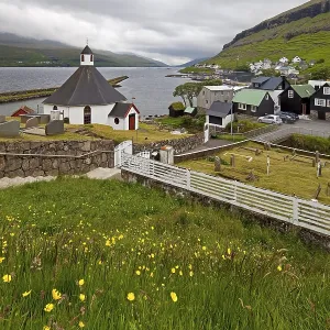 The small village Haldarsvik with the octagonal church and view of the Atlantic Ocean The small village Haldarsvik with the octagonal church and view of the Atlantic Ocean