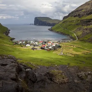 The small village of Tjornuvik with view of the Atlantic Ocean The small village of Tjornuvik with view of the Atlantic Ocean