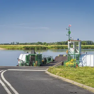 Small, vintage paddle steamer ferry operating on Oder River crossing between Poland and Germany Small, vintage paddle steamer ferry operating on Oder River crossing between Poland and Germany