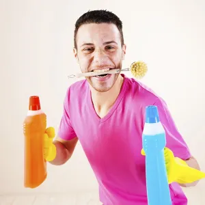Smiling man with a cleaning brush between his teeth