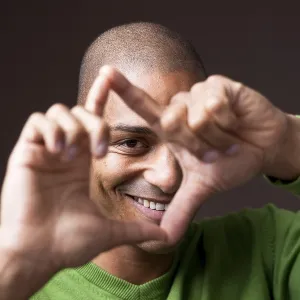 Smiling young man, gesticulating, portrait