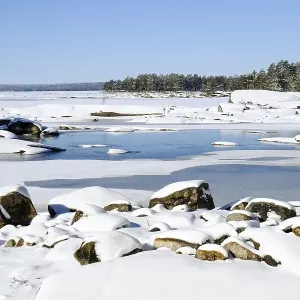 Snow-covered lake landscape in sunshine Snow-covered lake landscape in sunshine