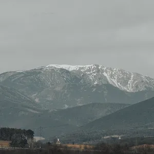 Snow-covered mountain landscape with cloudy sky Snow-covered mountain landscape with cloudy sky