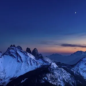Snow-covered mountain peaks of the Bosconero group at blue hour