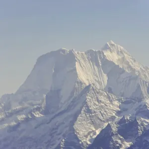 Snow-covered mountain peaks under a clear sky Snow-covered mountain peaks under a clear sky